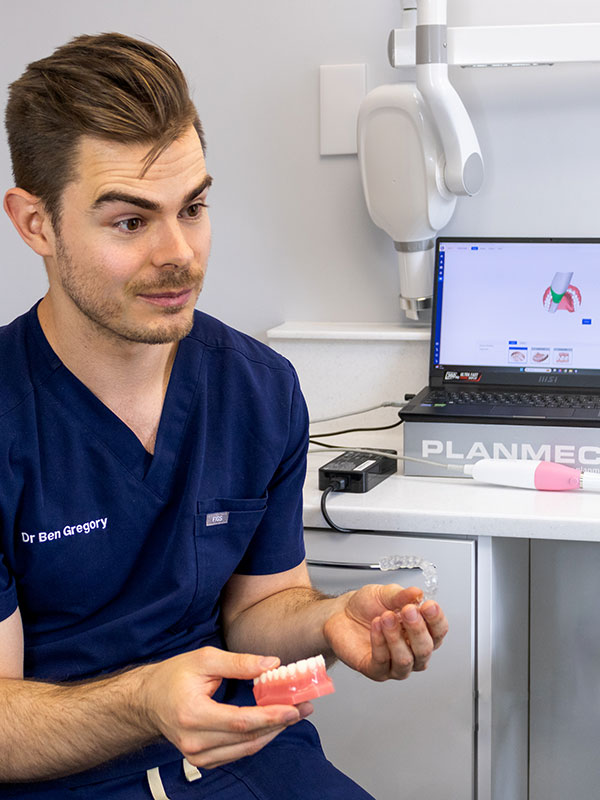 Dr Ben Gregory explaining how to use clear aligners to a patient